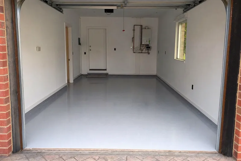 A clean coated grey garage floor seen from the open door — epoxy flooring, Bendigo. Illustrative example.
